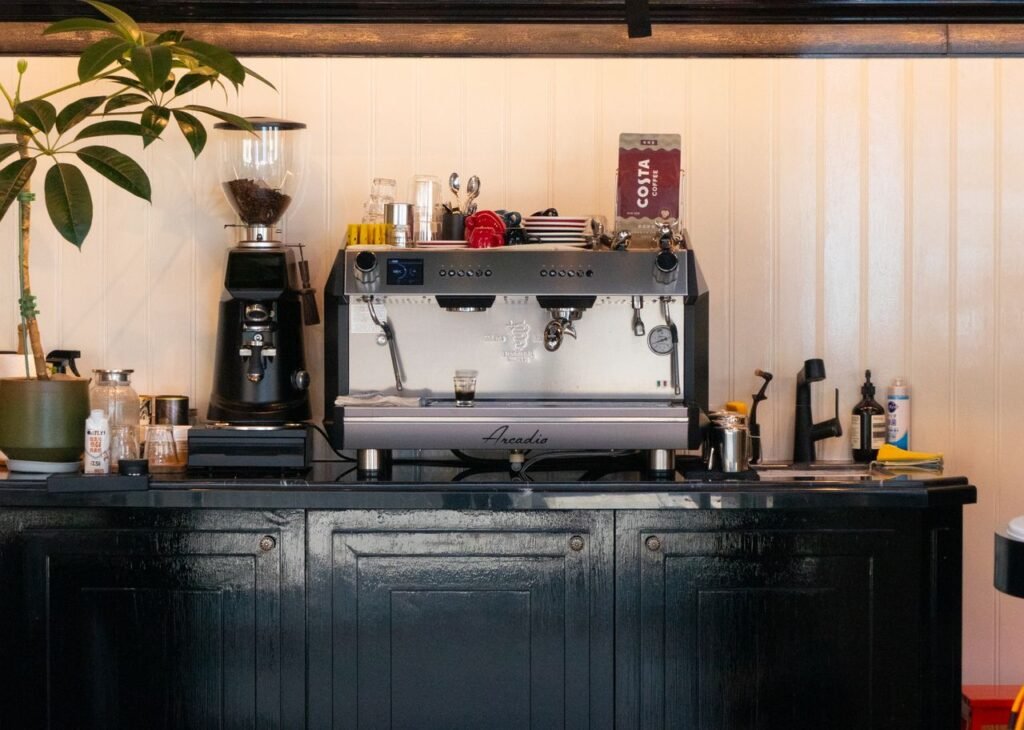 10 coffee station ideas for small kitchens featuring a modern coffee maker, floating shelves, coffee mugs, and stylish kitchen organization.