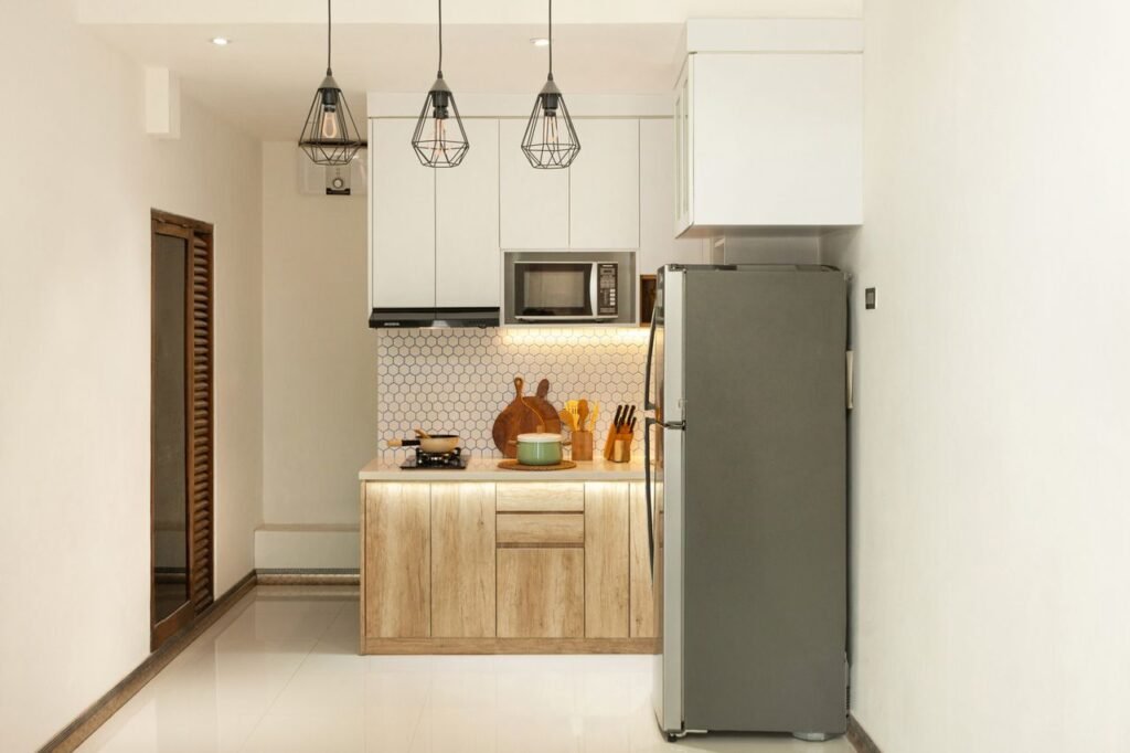 Modern small apartment kitchen with smart storage solutions, open shelves, white cabinets, wooden countertops, and stylish decor.